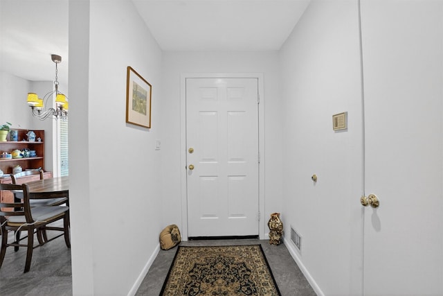 32 Spring Pond Dr, Ossining, NY 10562 - doorway to outside with a chandelier and concrete floors