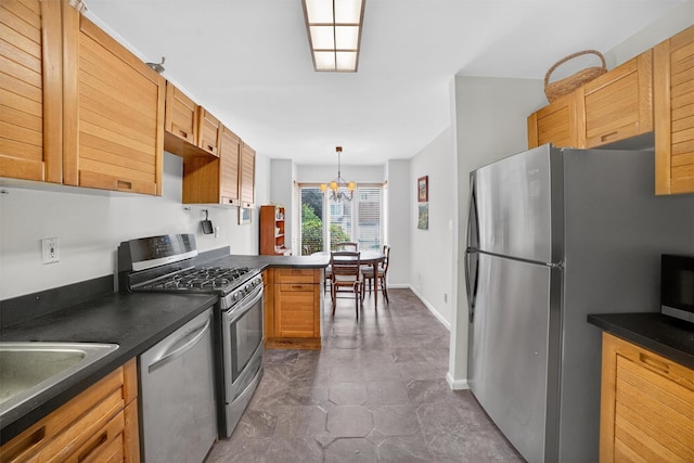 32 Spring Pond Dr, Ossining, NY 10562 - kitchen featuring appliances with stainless steel finishes, dark countertops, a chandelier, and pendant lighting