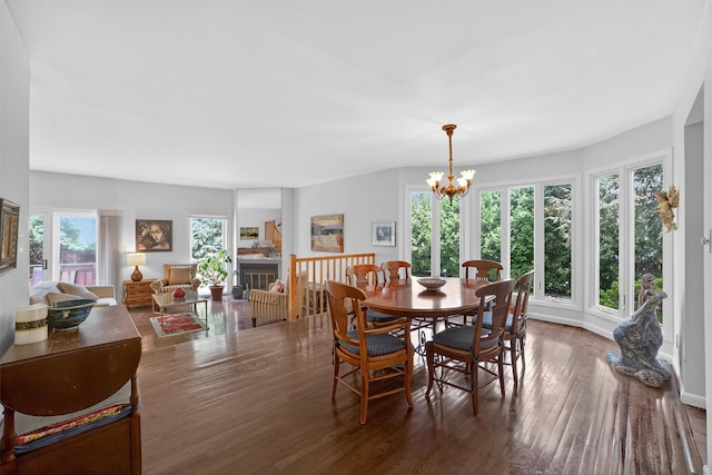 32 Spring Pond Dr, Ossining, NY 10562 - dining room featuring healthy amount of natural light, wood finished floors, a chandelier, and a glass covered fireplace