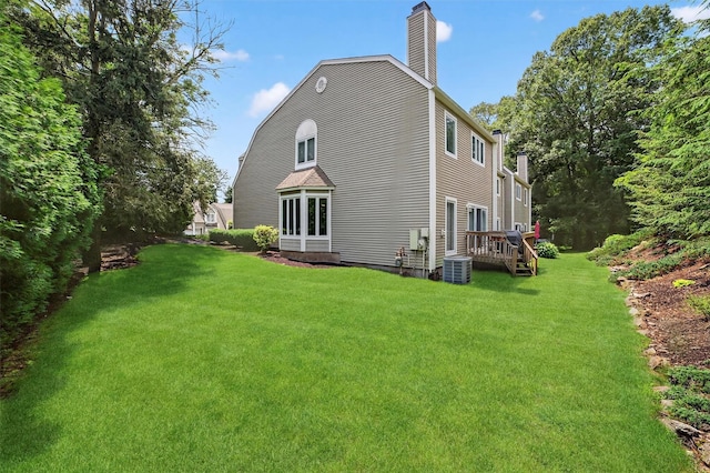 32 Spring Pond Dr, Ossining, NY 10562 - back of house featuring a chimney, a lawn, and a wooden deck