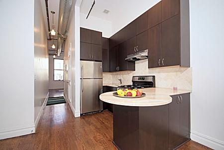 235 W 120th St, New York Manhattan, NY 10027 - kitchen with freestanding refrigerator, range, light countertops, under cabinet range hood, and a peninsula