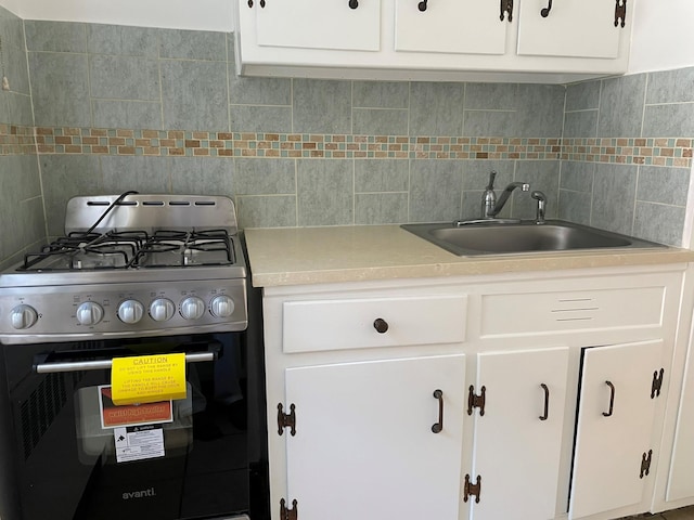 180 Pinewood Dr Unit 11, Hartsdale, NY 10530 - kitchen with stainless steel gas range, backsplash, white cabinetry, and light countertops