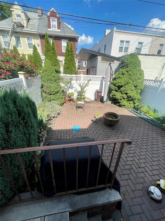 7863 79th Ln, Glendale, NY 11385 - fenced backyard featuring a patio area