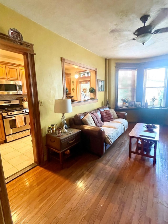 7863 79th Ln, Glendale, NY 11385 - living area with a ceiling fan and light wood-style flooring