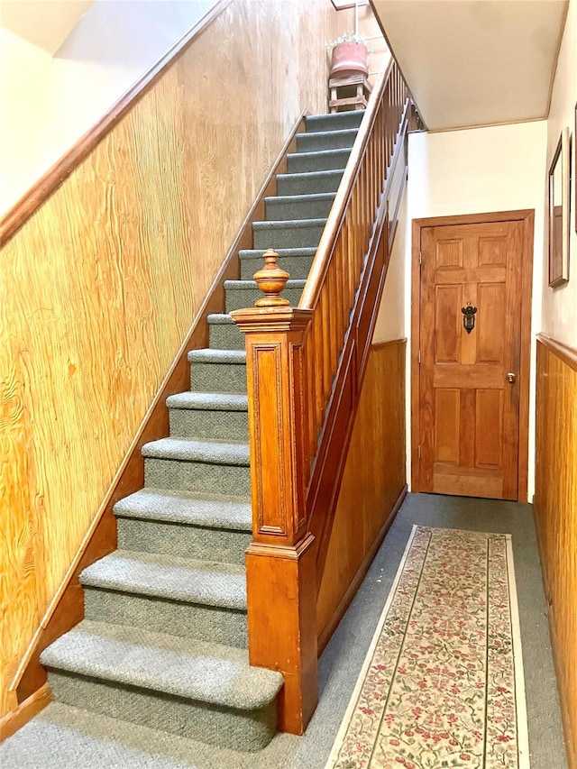 7863 79th Ln, Glendale, NY 11385 - staircase with carpet floors, wooden walls, and a wainscoted wall