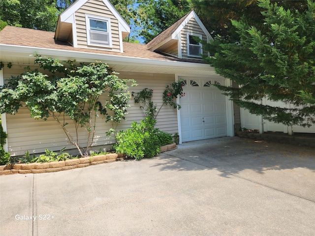 26 Long Beach Dr, Sound Beach, NY 11789 - view of front of house featuring a garage, driveway, and roof with shingles