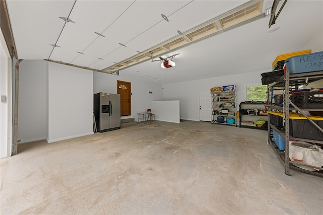 162 Airport Rd, New Hampton, NY 10958 - garage with stainless steel refrigerator with ice dispenser and a garage door opener