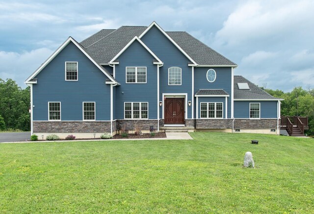 45 Jeffrey Dr, Pleasant Valley, NY 12569 - view of front of house featuring stone siding, a front yard, and roof with shingles