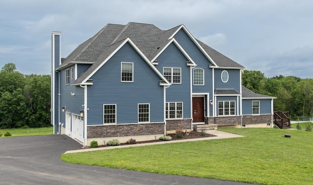 45 Jeffrey Dr, Pleasant Valley, NY 12569 - view of front of home with driveway, a chimney, a front lawn, a garage, and stone siding