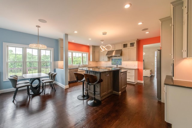 45 Jeffrey Dr, Pleasant Valley, NY 12569 - kitchen with under cabinet range hood, appliances with stainless steel finishes, a kitchen island, dark countertops, and recessed lighting