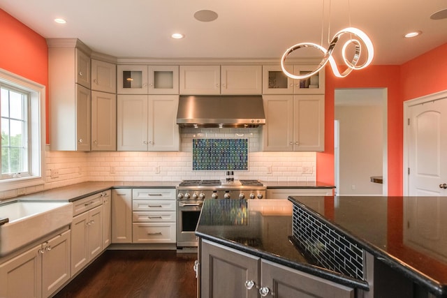 45 Jeffrey Dr, Pleasant Valley, NY 12569 - kitchen featuring exhaust hood, high end stainless steel range, glass insert cabinets, dark wood-type flooring, and backsplash