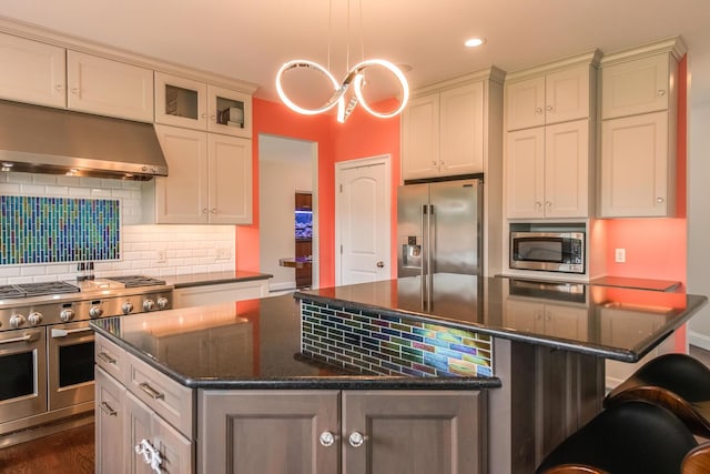 45 Jeffrey Dr, Pleasant Valley, NY 12569 - kitchen with premium appliances, under cabinet range hood, a kitchen island, decorative backsplash, and recessed lighting