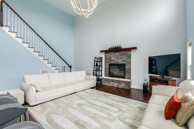 45 Jeffrey Dr, Pleasant Valley, NY 12569 - living area with a towering ceiling, wood finished floors, a chandelier, a stone fireplace, and stairs