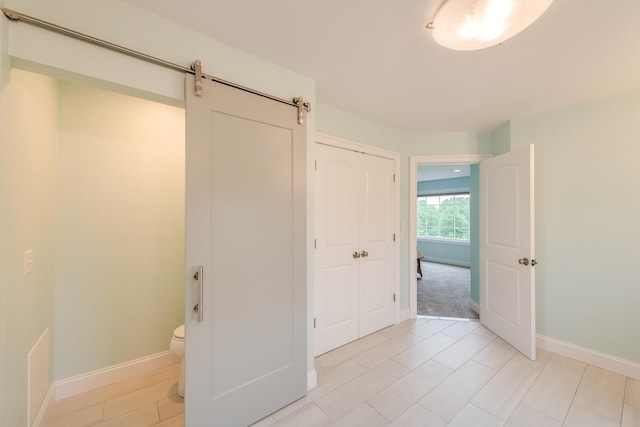 45 Jeffrey Dr, Pleasant Valley, NY 12569 - unfurnished bedroom featuring a barn door and light tile patterned floors
