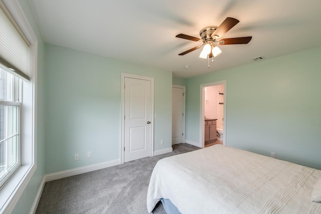 45 Jeffrey Dr, Pleasant Valley, NY 12569 - carpeted bedroom featuring multiple windows, ceiling fan, and connected bathroom