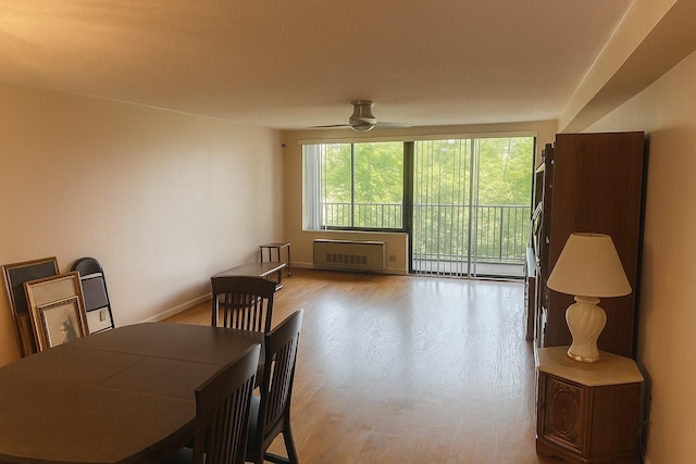 210-19 26th Ave Unit 3F, Bayside, NY 11360 - dining room featuring radiator heating unit, wood finished floors, ceiling fan, and a baseboard radiator