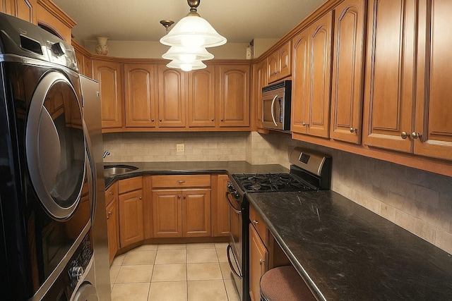 210-19 26th Ave Unit 3F, Bayside, NY 11360 - laundry area featuring stacked washer and clothes dryer, light tile patterned floors, and cabinet space