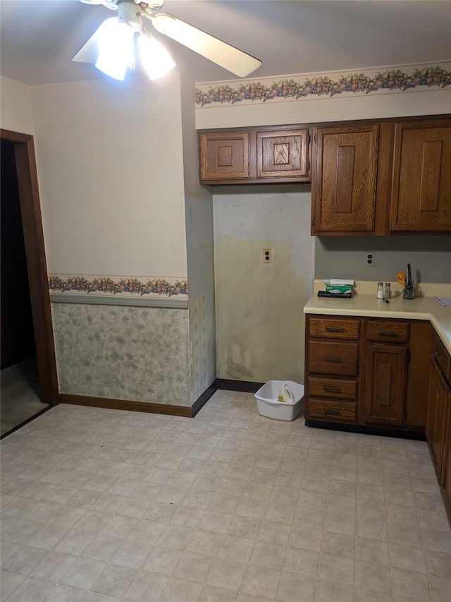 24 Delilah Ln, Plattekill, NY 12589 - kitchen with ceiling fan, light countertops, light flooring, brown cabinetry, and wallpapered walls