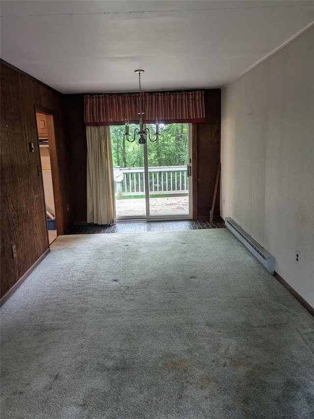 24 Delilah Ln, Plattekill, NY 12589 - carpeted spare room with a baseboard heating unit, a chandelier, and wooden walls
