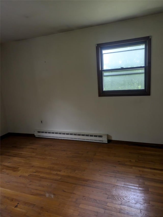24 Delilah Ln, Plattekill, NY 12589 - empty room with a baseboard heating unit and wood finished floors