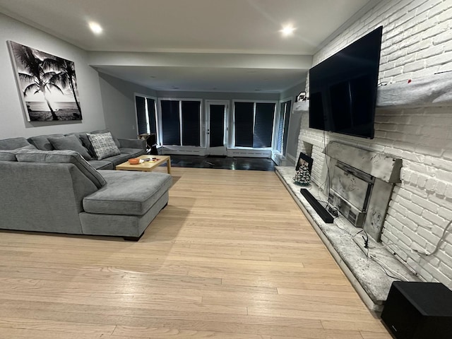 627 Haverstraw Rd, Airmont, NY 10901 - living room with a fireplace with raised hearth, light wood-type flooring, and recessed lighting