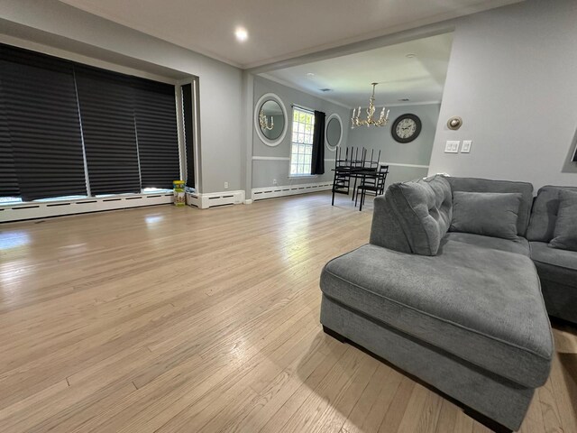 627 Haverstraw Rd, Airmont, NY 10901 - living area with baseboard heating, a chandelier, wood finished floors, and recessed lighting