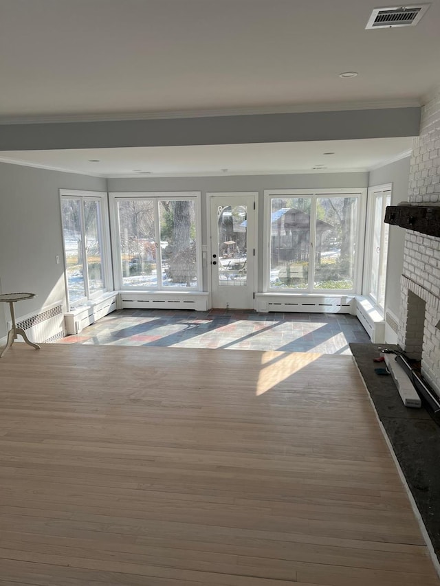 627 Haverstraw Rd, Airmont, NY 10901 - unfurnished living room featuring a baseboard radiator, crown molding, a fireplace, dark wood-type flooring, and a baseboard heating unit