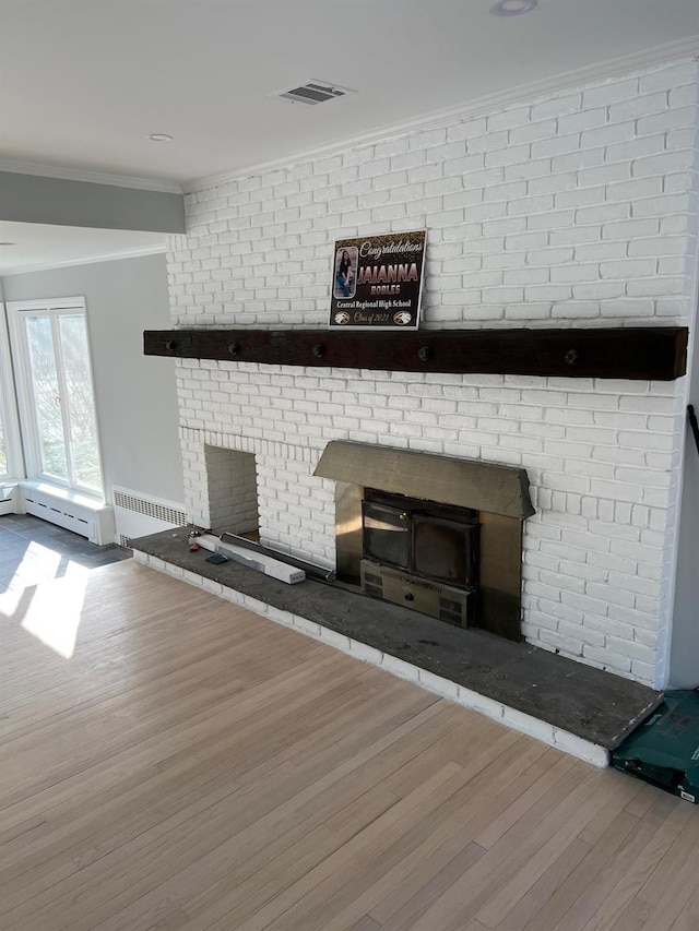627 Haverstraw Rd, Airmont, NY 10901 - unfurnished living room with a brick fireplace, wood finished floors, crown molding, and a baseboard heating unit