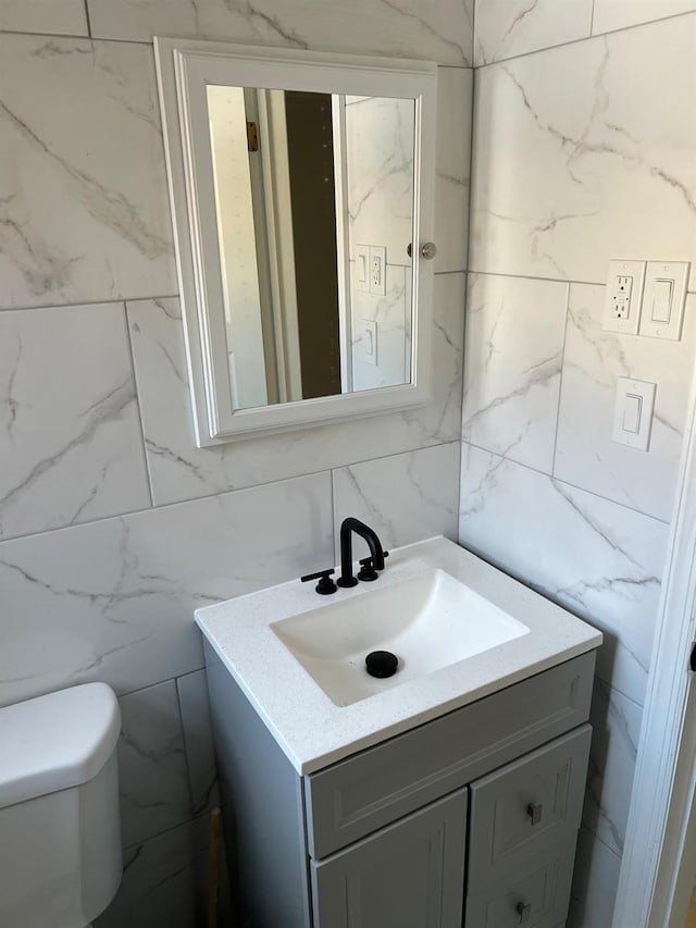 627 Haverstraw Rd, Airmont, NY 10901 - bathroom featuring tile walls, vanity, and tasteful backsplash