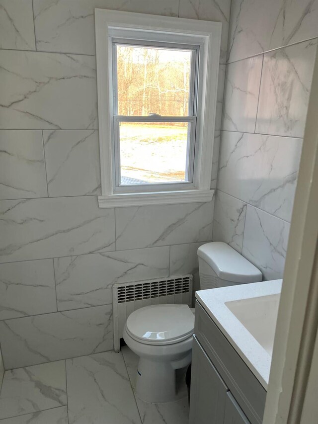 627 Haverstraw Rd, Airmont, NY 10901 - bathroom featuring marble finish flooring, radiator, vanity, and tile walls