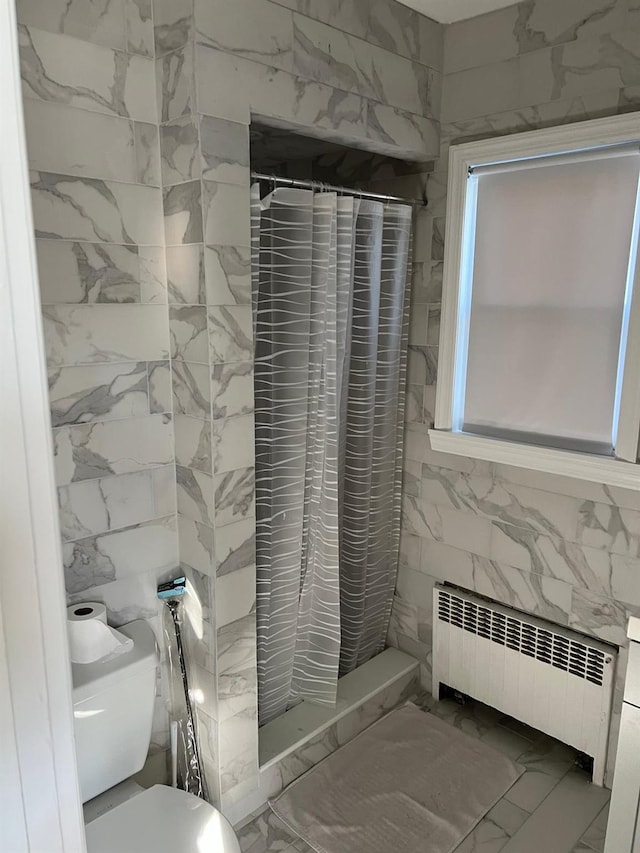 627 Haverstraw Rd, Airmont, NY 10901 - full bath with radiator, tile walls, marble finish flooring, and a shower stall