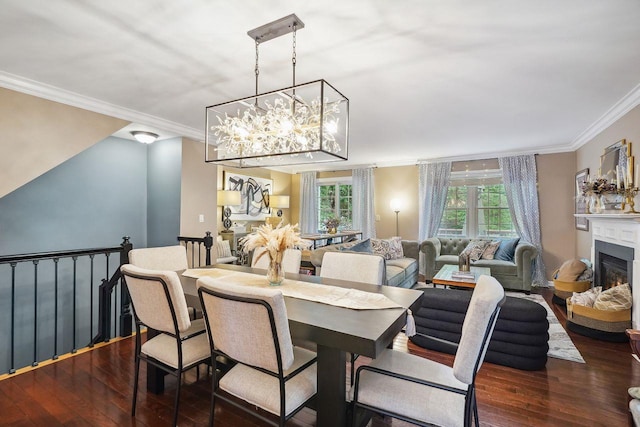 55 Winterberry Cir, Cross River, NY 10518 - dining area with dark wood-style flooring, crown molding, a chandelier, and a warm lit fireplace