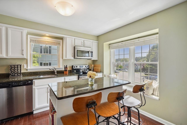 55 Winterberry Cir, Cross River, NY 10518 - kitchen with appliances with stainless steel finishes, a kitchen breakfast bar, white cabinets, and dark wood-style flooring