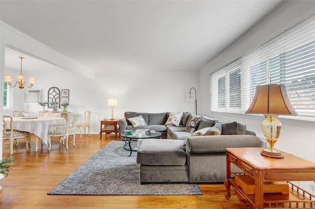 318 W Cortland Ave, Oceanside, NY 11572 - living room with healthy amount of natural light, a chandelier, and wood finished floors
