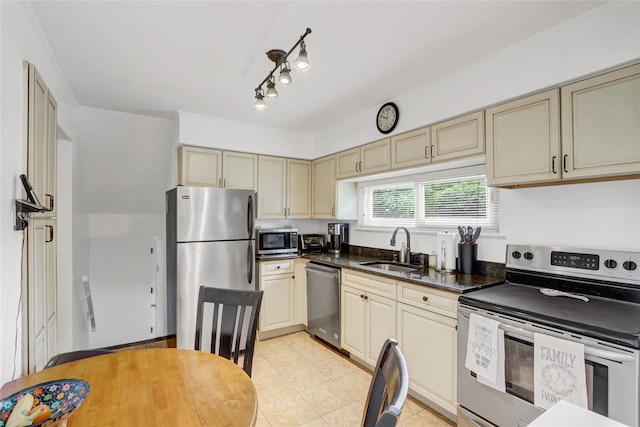 318 W Cortland Ave, Oceanside, NY 11572 - kitchen featuring appliances with stainless steel finishes, cream cabinets, and light tile patterned flooring
