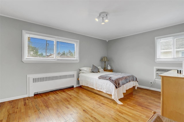 318 W Cortland Ave, Oceanside, NY 11572 - bedroom featuring radiator, light wood-type flooring, crown molding, and a wall unit AC