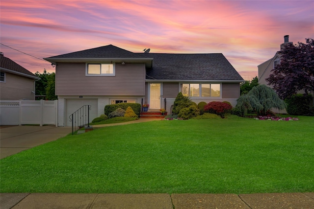 318 W Cortland Ave, Oceanside, NY 11572 - tri-level home featuring an attached garage, driveway, and a shingled roof