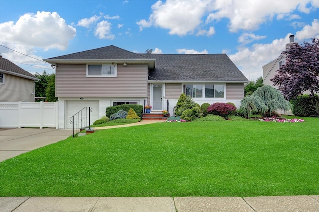 318 W Cortland Ave, Oceanside, NY 11572 - split level home featuring an attached garage, driveway, and roof with shingles
