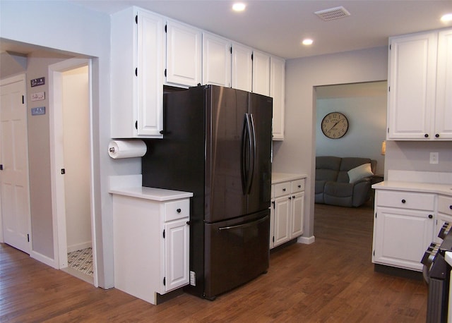 71 Strathmore Village Dr, South Setauket, NY 11720 - kitchen with freestanding refrigerator, white cabinetry, light countertops, dark wood-style flooring, and recessed lighting