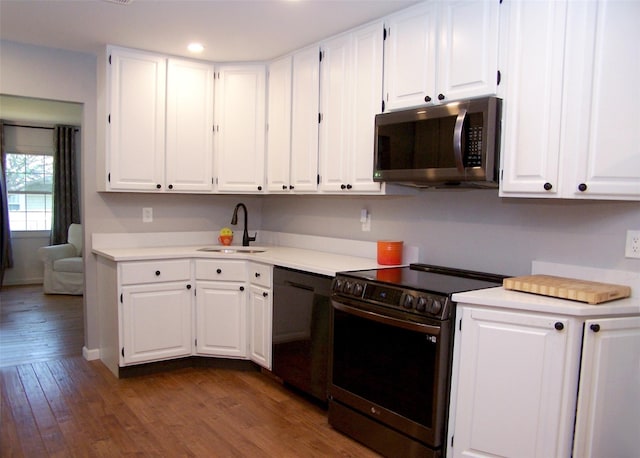 71 Strathmore Village Dr, South Setauket, NY 11720 - kitchen with stainless steel appliances, light countertops, white cabinets, and recessed lighting