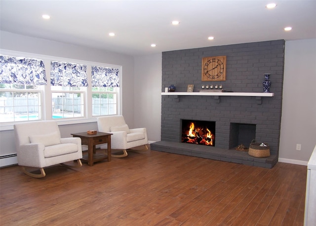 71 Strathmore Village Dr, South Setauket, NY 11720 - living room featuring wood finished floors, a fireplace, recessed lighting, and baseboard heating