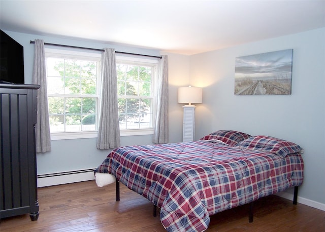 71 Strathmore Village Dr, South Setauket, NY 11720 - bedroom featuring baseboard heating and wood finished floors