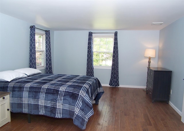 71 Strathmore Village Dr, South Setauket, NY 11720 - bedroom featuring multiple windows and dark wood-type flooring