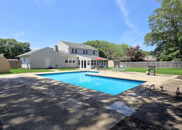 71 Strathmore Village Dr, South Setauket, NY 11720 - view of swimming pool featuring a patio area, a shed, and a fenced backyard
