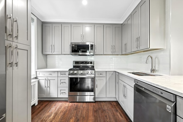 1133 Midland Ave Unit 4E, Bronxville, NY 10708 - kitchen with appliances with stainless steel finishes, gray cabinets, dark wood-style floors, and backsplash