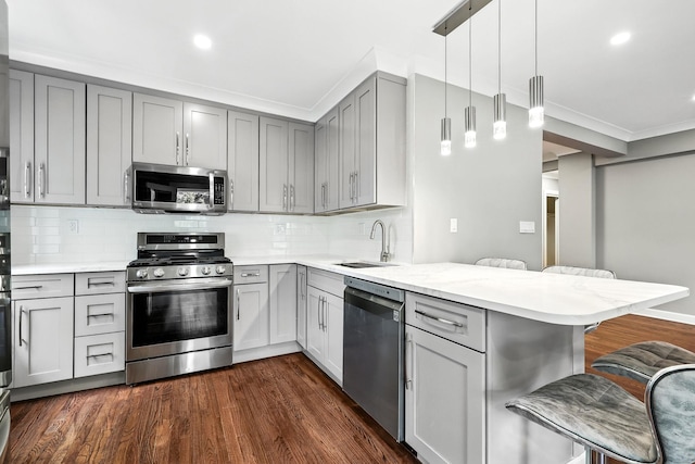 1133 Midland Ave Unit 4E, Bronxville, NY 10708 - kitchen featuring stainless steel appliances, gray cabinetry, a peninsula, a breakfast bar, and ornamental molding