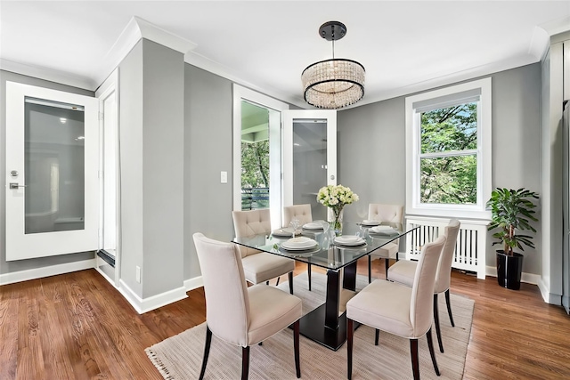 1133 Midland Ave Unit 4E, Bronxville, NY 10708 - dining space featuring radiator heating unit, wood finished floors, plenty of natural light, and crown molding