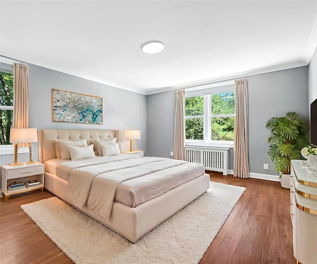 1133 Midland Ave Unit 4E, Bronxville, NY 10708 - bedroom with radiator, crown molding, multiple windows, and wood finished floors