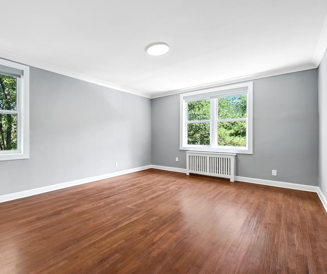 1133 Midland Ave Unit 4E, Bronxville, NY 10708 - empty room with radiator, ornamental molding, and dark wood finished floors