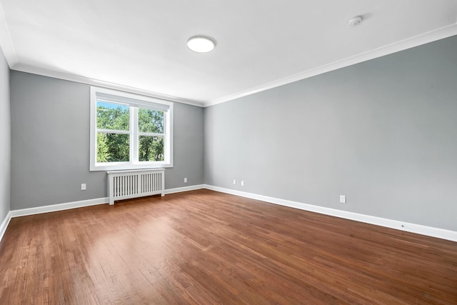 1133 Midland Ave Unit 4E, Bronxville, NY 10708 - spare room with radiator, a smoke detector, ornamental molding, and dark wood-type flooring